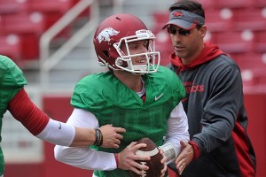 PHOTO BY MICHAEL WOODS Arkansas quarterback Austin Allen works with offensive coordinator Dan Enos during practice Saturday, April 11, 2015, at Donald W. Reynolds Razorback Stadium in Fayetteville.